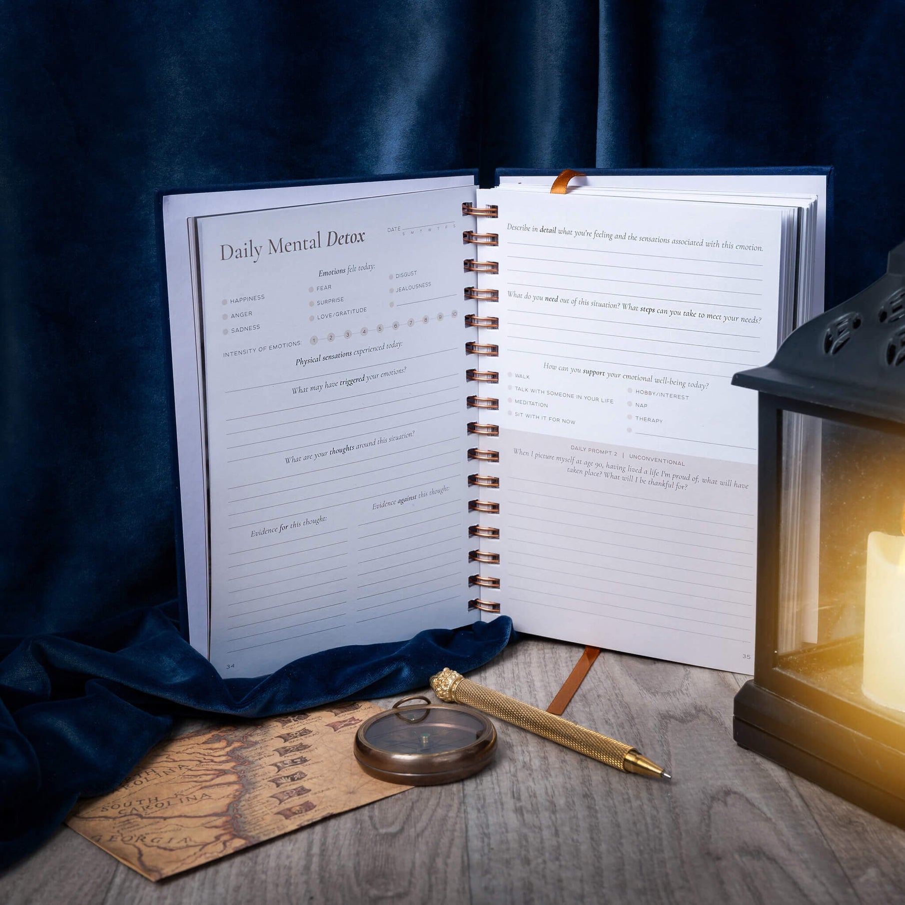 Open notebook with a pen and candle on a wooden surface